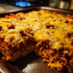 A close-up view of a freshly baked Dorito Casserole, loaded with melted cheese and seasoned ground beef.
