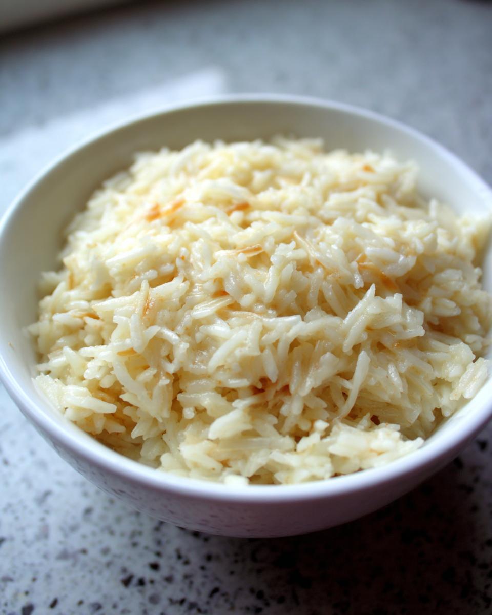 Close-up of a bowl filled with fluffy, creamy parmesan rice.